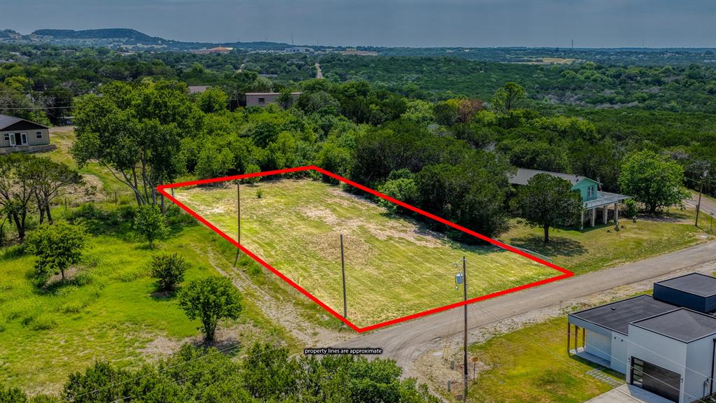 FULLY CLEARED DOUBLE LOT WITH LAKE VIEWS! Don't miss this incredible opportunity to own a fully cleared double lot totaling approximately 0.36 acres (15,474.3 square feet) in the lake access community of Comanche Harbor! With Granbury lake views, plenty of space to build, and a survey available, this property is ready for your plans and vision. Located in the lake access community of Comanche Harbor, residents enjoy fantastic amenities including two boat ramps, two parks, a basketball court, and a tennis court, making it easy to enjoy the lake lifestyle year round. Conveniently located just minutes from Granbury's fantastic parks, bike paths, walking trails, shopping, dining, live entertainment, and the rich history that makes Granbury one of Texas’ most treasured towns. Granbury has officially been named the #1 Best Historic Small Town in America for the 5th time by USA Today. Whether you're ready to build your dream home or invest for the future, this spacious, fully cleared double lot with beautiful lake views is an opportunity you won't want to miss. Come experience why life in Granbury is so easy to love. It’s time to grab those building plans. Don't let this opportunity pass you by, your future home awaits!