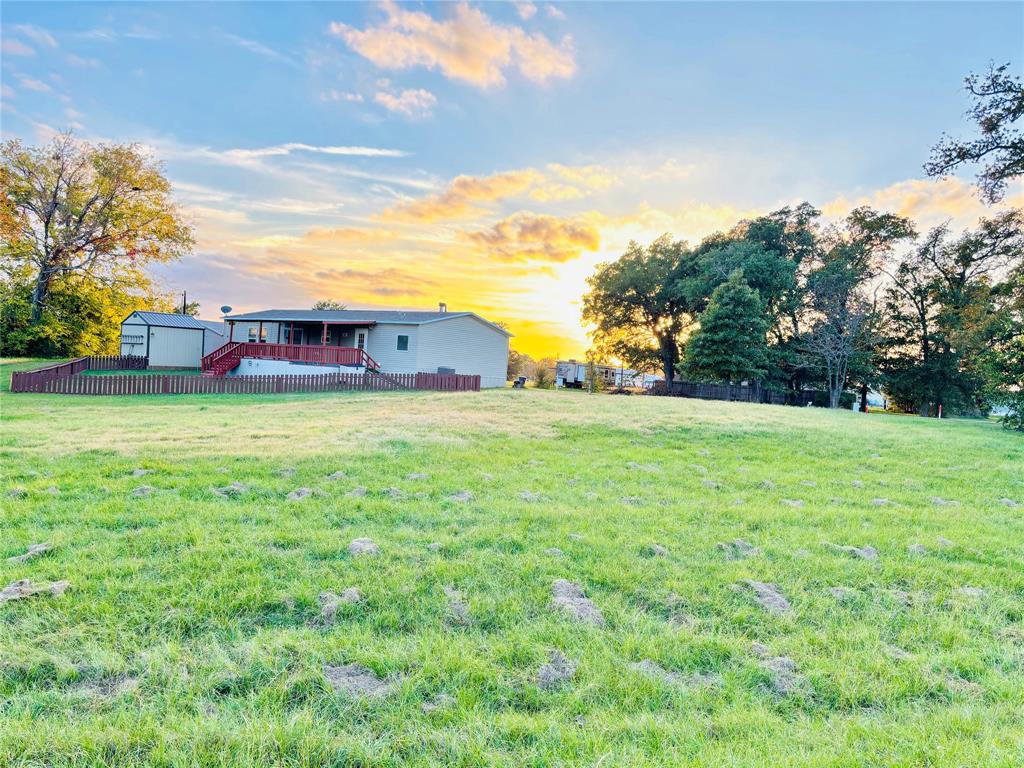 This impressive 50'x100' lot is nestled within a gated community offering direct access to the tranquil Lake Fork. Unimproved lot with Utilities readily available at the road, making it a blank canvas for you to create your dream home or fishing getaway. Holiday Village permits full-time residency and short or long-term rentals. Mobile homes should be under 5 years old to be allowed onto the property. Well water filtration facility and sewer services $65 each per month. Bring your recreational vehicles, boats, and fishing gear to fully enjoy the community's offerings, which encompass common fishing piers, boat ramps, a clubhouse, a salt water pool, playgrounds, mini golf, a basketball court, and picnic areas. Moreover, the community fosters a sense of camaraderie with monthly potluck gatherings, bingo nights, and paint classes. Ideal environment to connect with neighbors and form lasting friendships.