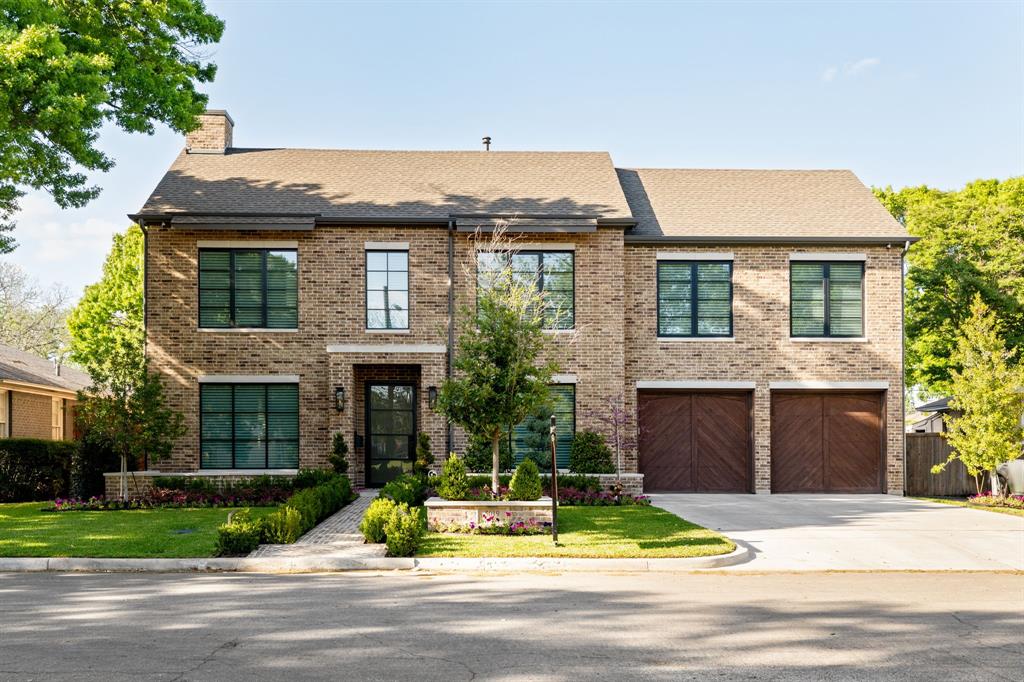 Discover 5019 Lark Lane, a six-bedroom, five-and-a-half-bath estate on a quarter-acre that blends timeless architecture with turnkey technology. A classic brick façade with black steel-framed windows, herringbone wood garage doors, and a brick walkway framed by manicured hedges sets refined curb appeal. Inside, floor-to-ceiling glass bathes the open plan in natural light, highlighting wide-plank white oak floors, designer brass lighting, and custom wall paneling—including a chic dining room with a black feature wall and sconces. The great room, anchored by exposed white oak ceiling beams, opens through a wall of multi-slide doors to the backyard. At the center, a chef’s kitchen showcases a plaster-wrapped vent hood, integrated refrigeration, natural stone counters with a slab backsplash, and an oversized white oak island with dual sinks and twin dishwashers, while a walk-in butler’s pantry streamlines daily living and effortless entertaining. Across both levels, restful suites and luxe baths feature marble surfaces and frameless glass showers; the serene vaulted primary retreat pairs a paneled feature wall with a spa bath offering dual vanities and a dedicated makeup station. Step outside to a true resort setting with a travertine terrace, a covered patio with a gas fireplace, ceiling heaters, and retractable shades, plus a built-in stainless outdoor kitchen. The 15,000-gallon heated and cooled pool includes a raised spa with spillover and a waterfall, complemented by a cedar pergola pavilion, a storage shed on slab, and a smart 14-zone irrigation system with integrated fertilization. This fully connected home offers whole-home automation for locks, lighting, and cameras; a Lorex 4K surveillance system; Wi-Fi–enabled appliances with extended warranties; and a 26-kWh natural-gas Generac generator with intelligent load management. Minutes to Downtown Dallas, Park Cities, and Love Field, it delivers the best of modern Dallas indoor-outdoor living.