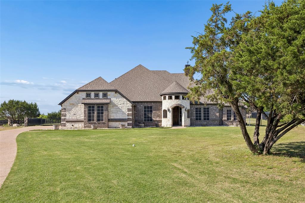 Experience luxury country living in this stunning Gated Community, 1 story home, with a private second primary suite, located on a sprawling 1 acre oversized lot in the highly sought-after Midlothian ISD. Nestled inside the exclusive gated community of The Summit in Lake Ridge of Cedar Hill, this beautifully maintained home feels like new and offers the perfect combination of elegance, comfort, and energy efficiency.

Featuring 4 bedrooms, 3 bathrooms, a dedicated office, and a 3 car garage, this thoughtfully designed home showcases hand-scraped hardwood floors, an open concept layout, and spacious living areas ideal for both everyday living and entertaining. The chef’s kitchen is truly the heart of the home with a gas cooktop, double ovens, oversized island, and seamless flow into the dining and living spaces overlooking the backyard retreat.

The luxurious primary suite is filled with natural light and offers French doors leading directly to the patio and resort style backyard complete with a beautiful pool and stone waterfall. The spa inspired bath features dual walk in closets, a jetted tub, and plenty of space to unwind. A rare second primary suite adds flexibility for multi-generational living or guests.

Built with efficiency in mind, this home is equipped with solar panels, backup battery storage, and solar window screens that significantly reduce energy costs while also providing backup power during outages, offering both peace of mind and long-term savings. 38 400W Rooftop mounted solar panels and 2 13.6Kwh batteries.
Step outside and enjoy your own private oasis with plenty of room to relax, entertain, and enjoy the quiet beauty of Ellis County living. This exceptional property offers luxury, functionality, and one of the most desirable locations in the area