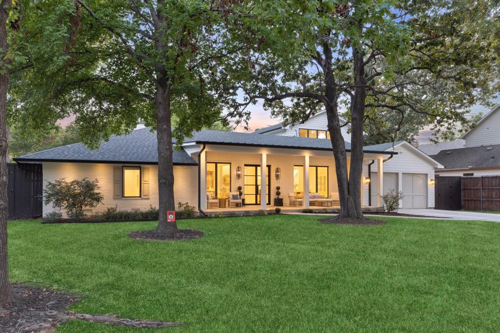 Completely reimagined in 2022, this Forest Hills retreat sits on a rare .4-acre lot just minutes from White Rock Lake and the Dallas Arboretum. With most living space, including the primary suite on the first floor, this beautifully remodeled home offers modern comfort, exceptional privacy, and a setting increasingly hard to find in East Dallas. The home features 5 bedrooms and 3.5 baths with a floor plan that largely lives like a single story. The primary suite, guest suite, game room, and main living areas are all located on the first floor, creating comfortable everyday living. The renovation included new plumbing, electrical, roof, framing, flooring, appliances, and designer finishes throughout, delivering the feel of modern construction while maintaining the charm of Forest Hills. The open kitchen is designed for entertaining with a large marble island, commercial-grade range, Serena & Lily lighting, butler’s pantry, walk-in pantry, and spacious breakfast area that flows into the family room. Upstairs are two additional bedrooms connected by a Jack-and-Jill bath plus a landing ideal for a study or homework space. Outside, the expansive backyard offers ample room for a future pool while maintaining generous green space. Covered front and rear porches overlook mature trees, creating a peaceful retreat tucked within the neighborhood. Surrounded by winding streets and towering trees, Forest Hills remains one of East Dallas’ most beloved communities, with convenient access to White Rock Lake, the Dallas Arboretum, Lakewood dining and shopping, and Downtown Dallas.