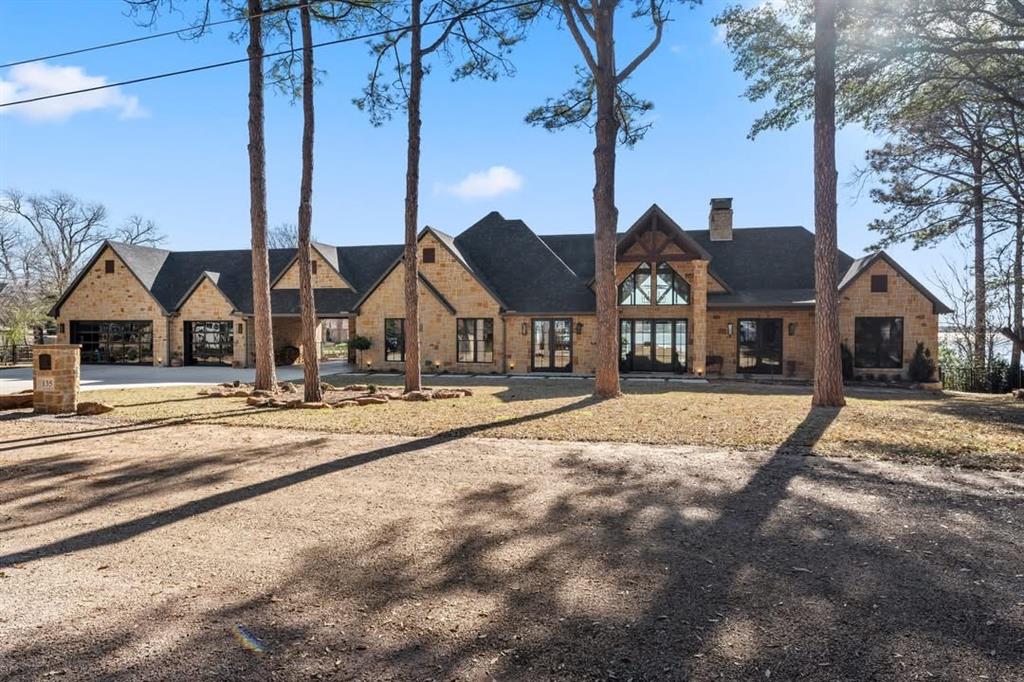 Stunning 2-year-old custom waterfront estate in the exclusive Three Harbors Peninsula of Mabank, offering open views from entry to Cedar Creek Lake. Featuring 4 bedrooms, 3 baths, including a luxurious primary suite with spa bath and walk-in closet, plus private ensuite guest room. Chef’s kitchen with Viking appliances, oak coffered ceilings, and pass-through bar window to the outdoor kitchen with Alfresco grill, refrigerator, and trash receptacle. Floor-to-ceiling windows front and back, traditional office with oak coffered ceilings, hand scraped hardwoods throughout, Sonos and Lutron smart home system. Outdoor living includes expansive patio deck, resort-style pool with travertine surround and hot tub, 2-slip Trex boathouse, and professional landscaping with 13-zone sprinkler. 3-car glass-door garage, porte cochère, Generac generator, and 1,000-gallon propane tank complete this exceptional lakefront retreat.
