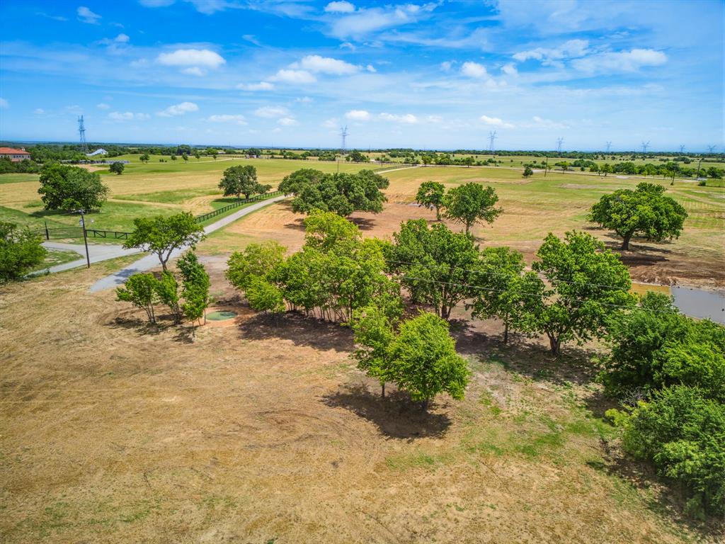 Stretch your legs on this 6.56-acre lot that offers much more than what you can find elsewhere. Neighboring an 800-acre tract of the LBJ Grasslands, this ag exempt property allows you to have free access to much more than just the land being sold. Lot 4 features scattered oak trees throughout and a newly constructed pond located on its south boundary. Enjoy beautiful sunsets as it boasts expansive views off the back of the property to the west overlooking the rolling topography of Wise County. Electricity is already in place to a 65 ft X 80 ft house pad as well as a 30 ft X 50 ft shop pad making it ready to build your dream home. You can choose whether your driveway comes off the county road or private road. This is the largest of 4 lots within the new subdivision of Skyfall Estates. It is deed restricted to preserve the quality of neighboring properties. An older water well is in place with a depth of 230 ft. A septic system would be needed.