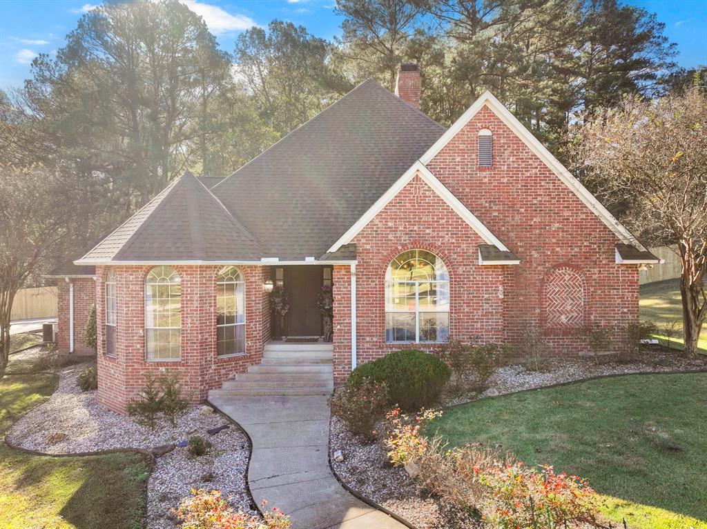 Nestled on a beautifully landscaped 1.35-acre cul-de-sac lot in the well-appointed Holly Creek addition, this refined single-story residence offers timeless elegance paired with resort-style outdoor living. Inside, rich wood floors, vaulted ceilings, and extensive built-ins create a warm yet sophisticated atmosphere, anchored by a spacious living area with fireplace and custom cabinetry. The chef’s kitchen features granite counters, double ovens, gas cooktop, island workspace, and abundant storage, flowing seamlessly into multiple dining spaces ideal for entertaining. The private primary suite offers a tranquil retreat with sitting area, spa-inspired bath, dual vanities, soaking tub, separate shower, and walk-in closet. Thoughtfully designed secondary bedrooms, office space with built-ins, and utility room with sink provide flexibility for modern living. Outdoors, the property transforms into a true backyard oasis with an in-ground pool, expansive patio, outdoor living area, and mature trees offering privacy and shade. A circular drive and side-entry garage enhance both convenience and curb appeal. A rare opportunity to enjoy space, elegance, and comfort in one place.