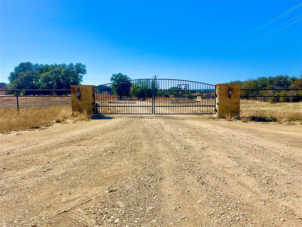 Ranches at Hamilton Ridge gated community tract 27 - This 10 acre property offers a premier opportunity for a permanent residence or a private weekend retreat in the heart of central Texas.  This is a gated community that has beautiful trees and rolling terrain with some of the highest elevations in Hamilton County providing panoramic 25 mile Hill country views.  Key improvements included gated access, private road access directly to the tract, and electricity available at the road or on-site.  The terrain is characterized by gorgeous live oaks, hardwoods, and native brush, offering privacy and a blank canvas for building your dream home.  The property is ideal for nature enthusiasts with abundant deer, turkey, hogs, and dove. 
This property is located approximately 10 minutes from Hamilton.  Hamilton is located 2 hours from Austin, 2 hours from Ft. Worth, and 1 hour from Waco.  The Ranches at Hamilton Ridge has light deed restrictions to maintain property values, focusing on residential and recreation use with a $250 annual fee due to maintain the private road and front entry gate.