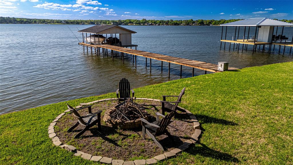 Enjoy incredible open-water living with 100 feet of shoreline and expansive, unobstructed lake views—truly a rare opportunity. Sunsets explode out over this deep water peninsula! Want year around boating and lake recreation? Look no further!
This stylish and inviting home was completely gutted and recreated over the last few years and WOW! From the kitchen with commercial appliances to the warm wood tones and sleek nuetral finishes to the spa like glass and tile baths, this one is magazine worthy! It is suited for both peaceful retreats or entertaining on a larger scale. The main level offers 3 bedrooms plus a compact built in bunk room , 3baths, and a spacious game room  with additional 4 bunks built along one wall, perfect for overflow guests. Downstairs, a private 1-bedroom, 1-bath efficiency-style guest suite. Outdoors, a large covered lakeside deck creates the perfect setting to relax and take in stunning sunset views beneath a canopy of mature trees. The well established expanse of rear lawn is bare foot perfect! This property captures the essence of lakeside living—comfortable, versatile, and unforgettable.
Furniture package is available via separate negotiation and barely used since purchase after remodel!
