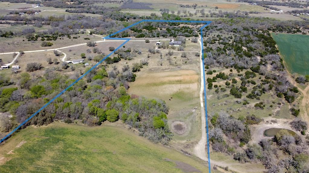 Custom built one owner home with screened porch, pool and amazing views is heaven on earth!! Do  you hear it calling your name, because you won't hear anything else at the end of the road but the wildlife calls!  Home sets in a quiet, peaceful, park-like setting surrounded by mature trees with an abundance of seasonal native plants and wildflowers. This 48 acre AG-Exempt acre property serves as the perfect place to host any of your livestock. Cottonwood Creek borders one of the pastures. Fenced and cross fenced, the fences are in fair condition and currently holding cattle.  There two stock ponds on the property one across form the house is in need of a cleanout. House well is 370 ft to the Trinity. The majority of the acreage is in native range mix with a couple hay fields behind the home. The precious homestead features vaulted ceilings 2 bedrooms, 2 full bathrooms, a stone wood burning fire place an open concept kitchen with built-in cabinets. Just outside your back door, you will find the most beautiful view with an oversized mature trees. Metal RV cover with a stone well house including two levels of storage and a 2 car carport leading into the house or backyard area. This little ranchette is priced to sell offering seclusion yet convenience being minutes from downtown Dublin and less than 30 minutes to the Cowboy Capital of the World in Stephenville, Tx. Ask us about our Local lender who has special programs to assist with down payment for qualified buyers.  Whether you are looking to enhance your horse or cattle operation, with a tiny bit of TLC this could be your forever Camp! This property serves as a great place to hunt and All owned Minerals will convey with the right offer.  Ask about our farming equipment available with an acceptable offer.  Additional property up to 100 acres is possibly available as well. A portion of this property is located in a Flood Plain.  IF planning to build in that area you will need to have flood insurance.
