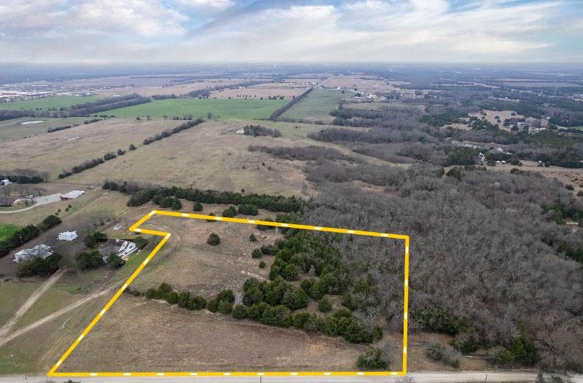 Located in Fannin County near Trenton, this 5-acre tract offers an opportunity for residential or small-scale agricultural use in a rural setting. The property features a blend of open pasture and scattered trees, creating a balance of usable ground and natural cover. With approximately 475 feet of frontage along a county-maintained road, access is direct and convenient for a future homesite, shop, or barn.

Electricity and county water are available along the road, subject to provider availability and requirements. The level to gently rolling terrain supports a variety of potential uses including a country home, hobby farm, or recreational retreat. The mix of grasses and tree cover provides space for gardening, small livestock, or outdoor activities while offering a sense of privacy from neighboring properties.

The tract is located approximately 0.75 miles from State Highway 121 and about 1.5 miles from U.S. Highway 69, providing convenient regional access. Melissa is approximately 14 miles southwest, Anna about 16 miles south, Blue Ridge roughly 10 miles southeast, Whitewright approximately 11 miles west, and Bonham about 16 miles northeast. U.S. Highway 75 (Central Expressway) is accessible via Highway 121, connecting the property to the greater North Texas area.

Surrounding properties consist primarily of agricultural land, rural residences, and open countryside. The combination of road frontage, utility availability, and proximity to major highways supports flexibility for a range of residential and land-based uses, subject to applicable local regulations.

Whether considered for a primary residence, weekend retreat, or small acreage investment, this Fannin County property offers manageable size, functional layout, and convenient access to nearby communities while maintaining a rural atmosphere.