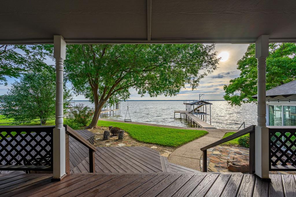 Nestled on an open-water lot with water year-round, this exceptional single-story home offers the ultimate lakeside lifestyle. The home features three spacious bedrooms and two bathrooms, with expansive windows throughout designed to frame breathtaking views of the manicured yard and shimmering lake. The interior flows seamlessly to a large outdoor patio, where the sunsets are abundant and a bird watcher's dream! This amazing property also features a versatile detached building, currently utilized as a personal gym, that offers incredible potential as an entertainment hub or guest suite. Offered furnished and featuring an extended driveway that accommodates six to eight vehicles, this property is a turnkey masterpiece perfectly suited for a primary residence or a high-performing short-term rental.  Completely reimagined in 2025, the boat dock was rebuilt with a dual jet ski lift, spacious decking for fishing or entertaining, plus a magnificent upper deck perfectly positioned for sunset viewing. The dock can be easily converted back to accommodate a 22ft boat, as the motor and support pole both remain at the home. 
The nearby HOA community park has recently been updated to the perfect entertaining venue for those large gatherings, that includes a covered pavilion, kitchen, bathrooms, tables, fishing dock and a lake beach entry for on the lake relaxation! 
Home is within 5 miles of grocery stores and restaurants!  Search address on YouTube for cinematic videos of the property.