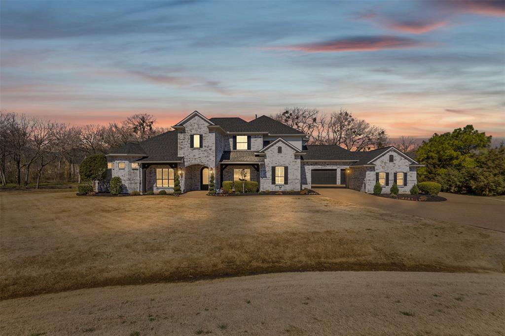 Nestled on a 2.36-acre lot in the sought-after Argyle ISD, this stunning residence embodies the epitome of modern, convenient and comfortable luxury living. Step inside to find a welcoming foyer with spiral staircase opening to an office on one side. Light wood flooring guides you through the open floor plan, which artfully integrates the kitchen, dining and living area—perfect for both entertaining and everyday living. Large windows fill the space in light and offer scenic views. The kitchen’s showstopper is a striking focal wall with decorative tile soaring to the ceiling, complemented by sleek marble backsplash and countertops. Thoughtfully placed appliances offer a clean, open aesthetic, paired with white shaker-style cabinets, farmhouse sink and professional-grade range. Outside, a private retreat awaits with sparkling pool and an estate-sized backyard. Located on a quiet cul-de-sac, this home strikes the perfect balance between peaceful seclusion and neighborhood living.