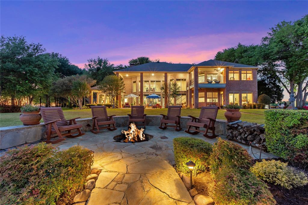 This breathtakingly majestic home sits on .90 beautifully landscaped acres with 239 ft of open waterfront on Arbor Island in Pinnacle Club on Cedar Creek Lake. Prepare to be wowed by the spacious open concept living room with custom tile floors, gas fireplace and 25 ft high ceilings and windows showcasing miles of open water view. Meticulously maintained, the home offers 4 water view bedrooms with ensuite baths with separate tubs, showers and walk in closets. Flex room could be 5th bedroom, workout, office or hobby room. Kitchen features wrap around bar seating, Wolf built in refrigerator, double ovens, island cooktop grill, 2 dishwashers and ice machine. Walk in pantry with wine cellar. Enjoy sunrises and sunsets from the covered patio, balcony or on top of the boathouse party deck. Oversized 3 car garage plus golf cart parking. Deep water boathouse for 2 boats and 4 personal water craft.  HOA includes social, tennis, pickle ball swimming, dining, exercise room. Golf available.