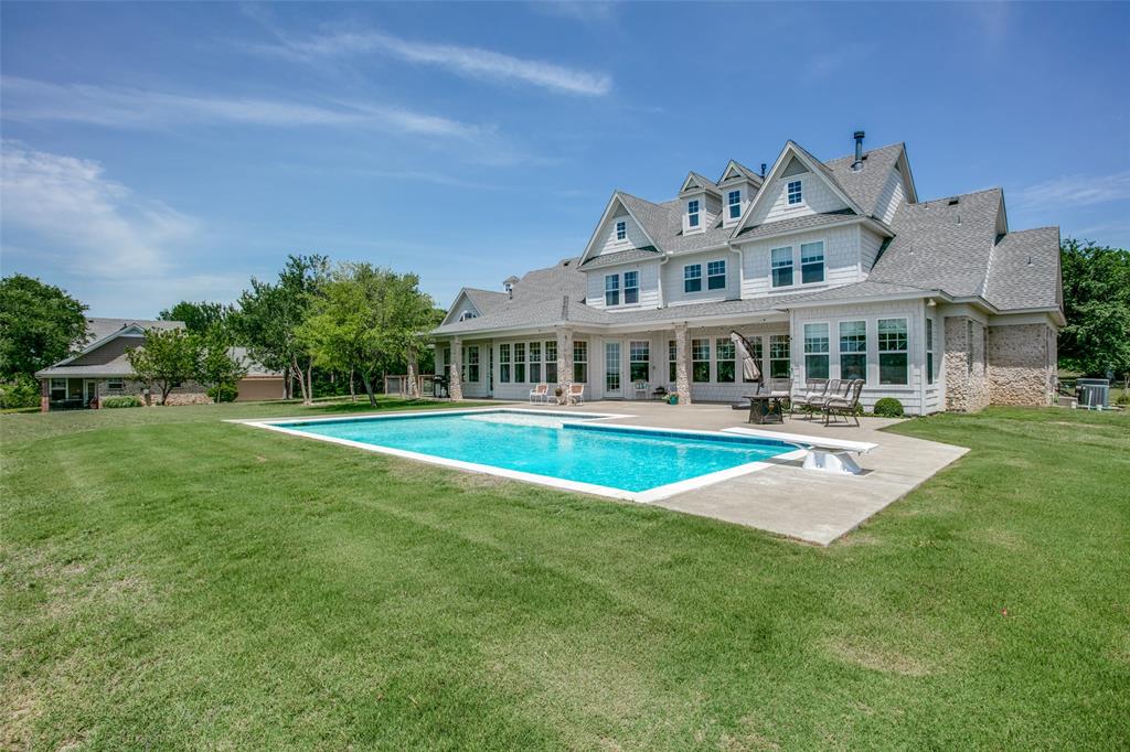 Hamptons oasis in Texas! This beautiful custom home sits on 16.8 acres with stunning views and additional home. The main home features 5 bedrooms, 4 bathrooms and beautiful views as soon as you walk in the front door. Downstairs you will find an open living area, large eat-in kitchen with walk-in pantry, formal dining room, along with an office and beautifully remodeled master suite with sitting area. Upstairs you will find 4 great sized bedrooms served by 2 jack and jill bathrooms, a game room and an additional 750 square feet of multi-purpose space that was recently finished out. Still need more space... how about a separate 2k square foot home right next door!? The guest home features 3 bedrooms, 2.5 bathrooms as well as a living room, kitchen, laundry, attached two car garage and private patio. Outside you will find incredible views overlooking Denton Creek with a large patio and diving pool, perfect for entertaining and fantastic firework views! You do not want to miss this one!
