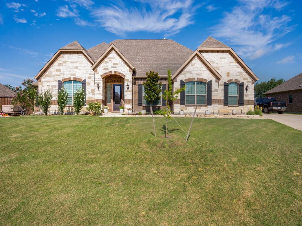 Welcome to this beautifully appointed 4 bedroom, 3.5 bath home offering exceptional curb appeal, sophisticated finishes. This home features 2 primary suites, 2 living areas, and 2 dining areas. The striking stone and brick facade, manicured lawn, and inviting entry create a memorable first impression.

Inside, an open concept floor plan is designed for both everyday living and entertaining, featuring two primary suites, two living areas, and two dining areas. The second, smaller primary suite is at the other end of the guest wing making it a perfect in-law suite or guest room. The main living room showcases soaring ceilings, abundant natural light, fireplace, and seamless flow into the chef inspired kitchen.

The kitchen is a true showpiece, featuring an oversized granite island with seating, custom cabinetry, stainless steel appliances, double ovens, a subway tile backsplash, walk in pantry, butler's pantry, and generous counter space. The expansive breakfast bar is the perfect gathering spot for family and friends, working from home, or for kids to finish their homework.

A second living area with double door access offers incredible flexibility and can serve as a home office, media room, fitness room, playroom, or even a fifth bedroom.

Situated on more than one acre, the backyard feels like your own private park. Designed for relaxation and entertaining, the outdoor space features an outdoor kitchen, mature trees, lush landscaping, and an oversized custom pergola. The covered back patio and oversized pergola make it so easy to host family and friends for outdoor dining, enjoying a quiet moment, or for cheering on the kids during a backyard talent show.

Move in ready and impeccably maintained, this stunning home offers the perfect blend of comfort, style, and functionality. Come experience everything this exceptional property has to offer.