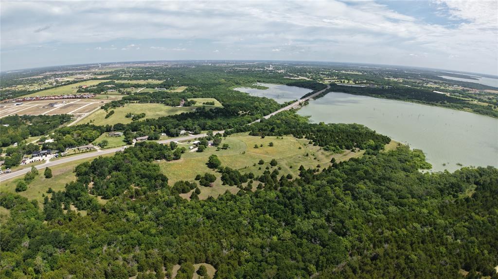 Magnificent incredible property that backs up to the Corps of Engineers land overlooking Lake Lavon. ±7.66 acres with a main house that is very nicely finished out. Property is currently used as residential but has tremendous commercial or development potential. The property is in the county and removed from the ETJ, however if a developer decides to bring in sewer from one of the nearby developments, then it would need to annex into the city. This is the last property on the left when leaving the peninsula. It would be ideal for a retail center or a mixed use type development. Perhaps homes, townhomes or apartments overlooking the lake in back. It is truly a unique offering and rare opportunity. Just minutes to major shopping in Allen and McKinney. About 20 minutes to Hwy 75 or about 10 minutes to 380 in Princeton. Walmart is about 10 minutes away in Lucas. Buyer to verify all information.