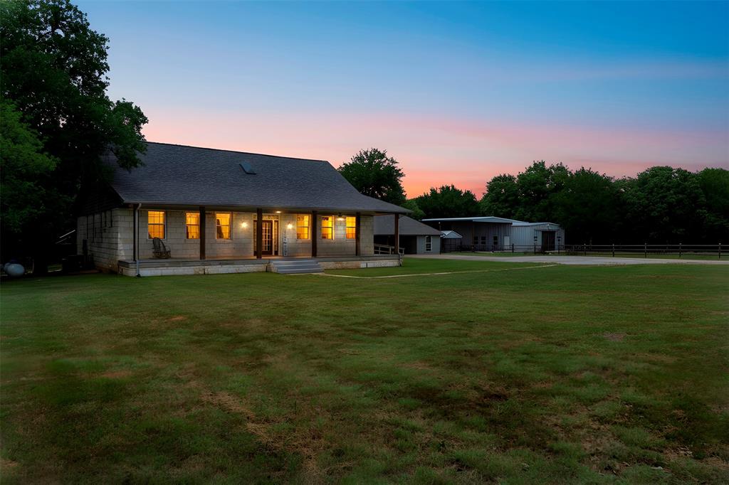 Come check out the Ultimate 12.5 Acre Private Retreat only minutes from Lake Granbury. Discover unparalleled serenity with this  picturesque retreat, perfectly positioned amidst a lush canopy of mature oak and mesquite trees. Accessed via two private gated entrances, this meticulously maintained property is fully cross-fenced, offering an ideal setup for livestock, horses, or a private homestead. Upon entry, you are greeted by stunning open meadows that transition seamlessly into a heavily wooded and tranquil landscape, providing a rare sense of seclusion and natural beauty. At the heart of the estate is a sophisticated 4-bedroom, 3-bathroom Craftsman-style home. The residence exudes curb appeal with an expansive, welcoming front porch designed for quiet mornings and breathtaking sunset views. The interior craftsmanship is matched by an extraordinary outdoor oasis featuring a sparkling in-ground pool and integrated hot tub, creating a resort-like atmosphere for relaxation and leisure. Enhancing the property’s versatility is a 1,000-square-foot studio-style, full open concept pool house.This fully self-contained living space features a full kitchen,a modern bathroom,and a spacious walk-in closet and a stone wood burning fireplace.Whether utilized as a guest or mother-in-law suite,  office,or outdoor entertaining,this space offers endless possibilities.For the hobbyist or professional, the property includes a massive barn-shop, providing ample room for equipment,projects, or storage.Additionally,a dedicated parking pad for an RV or boat storage comes complete with full hookups. Whether you are seeking a peaceful permanent residence, a working ranch for cattle and horses, or a sophisticated Weekend getawayretreat? This rural escape offers unlimited potential.Towering trees, lush pastures, a well AND co-op water, generator, whole house filtration and tankless water heater- this property is a rare find in today’s market. Bring those Pinterest ideas and make this home!