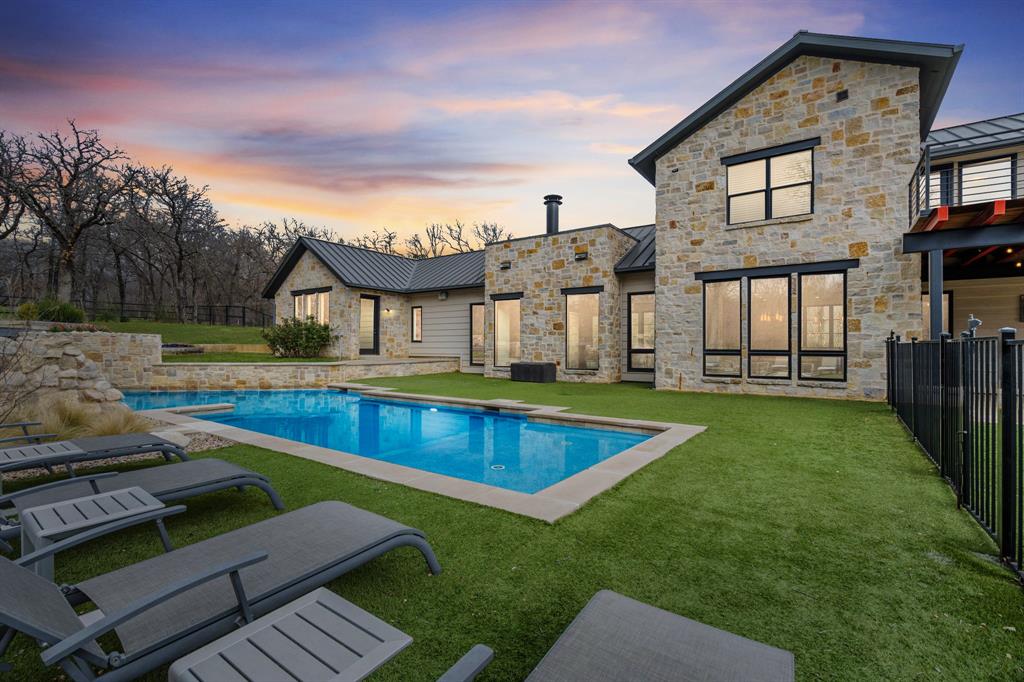 First time to market, this custom estate built by Kenneth Graham Custom Homes is located in the Country Oak Estates addition of Hickory Creek, Texas within Lake Dallas ISD and sits on approximately 2.5 acres with no HOA and now at an IMPROVED PRICE! *OWNER FINANCING AVAILABLE*

The main level offers a highly functional layout designed for everyday living and entertaining. Downstairs includes the primary suite with double walk-in closets and private stone courtyard access, an additional bedroom with full en-suite bathroom, a dedicated study, second office or flex space, open living area with stone fireplace and magnetic feature wall, dining area, and a chef’s kitchen. The kitchen features Patagonia stone countertops, custom cabinetry with pull-out storage, walk-in pantry with built-ins, and a full Thermador appliance package including a 48-inch gas cooktop, 30-inch refrigerator, 30-inch freezer, and dishwasher. Additional main level features include polished concrete floors, white oak flooring in the entry and primary suite, laundry room with mud bench and sink, leathered granite countertops in the laundry, pool bath, and a 3-car garage.

The second floor includes two bedrooms, two full bathrooms, and an additional living area, along with two second-story patios overlooking the front and back of the property, providing elevated views of the surrounding acreage.

Outdoor features include a saltwater pool, artificial turf, irrigation system, additional parking in the front and rear of the property, posted fencing, and a private tree-lined drive providing privacy from the road. Additional improvements include a carbon filtration system and custom window shades.

Country Oak Estates offers an acreage setting in Hickory Creek with convenient access to Lake Lewisville, I-35E, Denton, and surrounding North Texas communities.