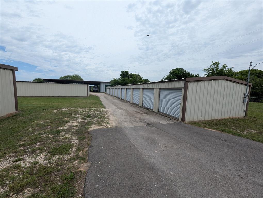 Excellent investment opportunity on the growing Fort Worth side of Granbury. Conveniently located just minutes from Hwy 377, this established self-storage facility offers multiple income-producing options with a mix of covered RV and boat storage, traditional storage units, and additional open parking space for boats, trailers, and RVs.

The property features 14 oversized 12x40 covered RV and boat storage spaces, 24 10x10 storage units, 8 10x24 storage units, and 6 10x20 storage units designed to accommodate a variety of storage needs. In addition, the property includes a large and versatile shop with electricity that could serve as a workshop, business space, or additional premium storage unit.

With easy access, strong visibility, and close proximity to Hwy 377, this property is positioned to serve the growing demand for storage in the Granbury area. The combination of covered storage, traditional units, and open parking creates multiple revenue streams and long-term investment potential. Rare opportunity to own a turnkey commercial storage facility in a rapidly expanding area of Hood County.