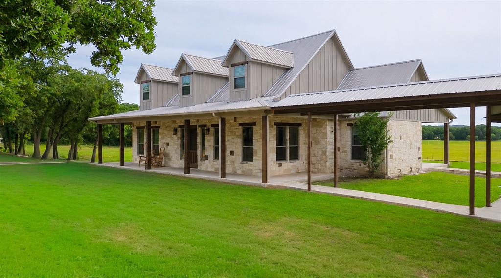 Rare Multi-Housing Ranchette on 80 Acres – 6085 County Road 146, Lipan, Texas 76462
This hard-to-find property has it all for the horseman, cattleman, or outdoorsman seeking seclusion. This beautiful hill country style custom home, tucked off the country road through a field of oak trees, overlooks a 30-acre coastal bermuda field. The adjacent 10-acre property is included with this listing and includes a newly remodeled 2 bedroom, 2 bath home and bungalow. The ranch features elevated new pipe fencing throughout for durability and clean looks, multiple loafing sheds for livestock comfort, and newly built covered cattle pens complete with hydrants for efficient handling and watering.  Additional highlights include a custom screened pavilion with a bar and entertainment area — perfect for hosting family, friends, or clients — plus a fully remodeled bunkhouse offering flexible guest or worker quarters.
Whether you’re running cattle, seeking a weekend getaway, or wanting a private North Texas retreat with strong infrastructure already in place, this Lipan ranch delivers functionality, upgrades, and lifestyle all in one package.
Ranch Features & Improvements:
• Beautiful new pipe fencing across the front, with strong fencing and cross-fencing throughout the property
• Newly built and covered cattle pens
• Multiple loafing sheds
• Custom screened pavilion with entertainment bar area for dining and gatherings
• Bonus, newly remodeled, 2-bedroom, 1-bath bunkhouse with a loft is built into the shop with its own custom flair 
• +4,000 sqft Storage and hay barn area (40 x70) and (50 x 30)
• 30-acre coastal bermuda field producing 150–250 horse-quality round bales per year (dependent on rainfall)
• Watch 150-class deer and turkey right from the property. Must see in person to appreciate all that this one-of-a-kind ranch offers.
Main Home: 4 bed  3 bath  2,565–3,176 sqft 65 acres Built 2019 Multiple living quarters  Bunk: 1 bd 1 bath 
Bonus Home: 2 bed  2 bath