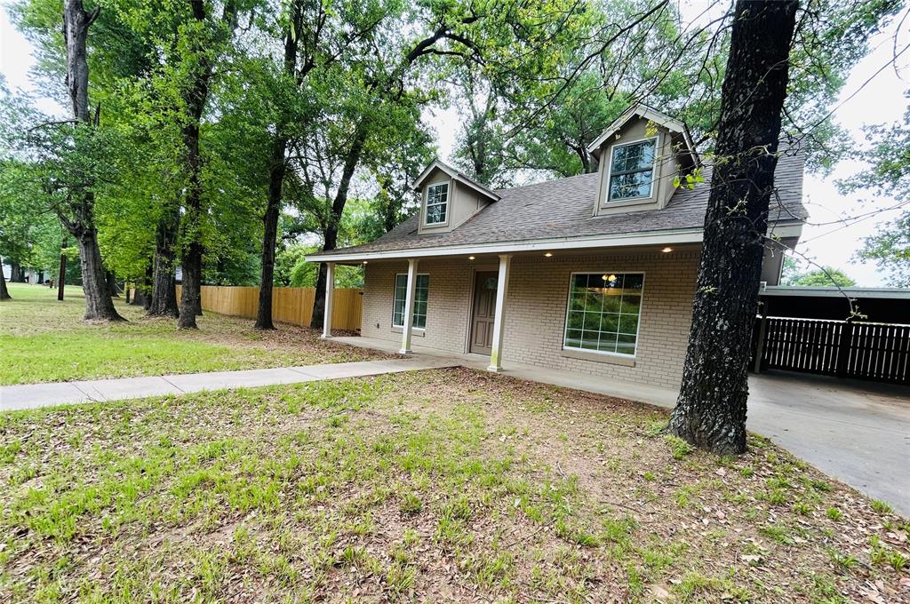 Recently renovated and move-in ready, this charming home sits on nearly 1 acre in the quiet Westwood Beach Subdivision, just a short walk from the community’s gated private boat ramp providing easy access to the lake. With plenty of space for kids and pets to run and play, this 3-bedroom, 2-bath home is ready for a new family to enjoy. The home features a beautifully updated kitchen with gray shaker-style cabinetry, recessed lighting, updated countertops, and stainless steel appliances. A convenient bar area offers seating for up to four, while the dining area comfortably seats six—ideal for family dinners and entertaining guests. The spacious living room showcases a full wall of windows, filling the space with natural light.
The primary bedroom is located on the first floor and can accommodate a king-size bed. The remodeled ensuite bathroom features both a tiled shower and tub. Upstairs, you’ll find two additional spacious bedrooms and a full bathroom, creating a great layout for family members or guests. A stackable washer and dryer laundry area is also located upstairs for convenience. Outside, the expansive lot provides plenty of room to park an RV, boat, or other lake toys, with three entrance gates for easy access. Additional character comes from the repurposed original 1980s staircase and railings, adding charm and a unique touch to the home. Westwood Beach Subdivision offers a voluntary POA with amenities that include a lighted fishing pier, sandy beach area, picnic tables, patio space, and a private boat ramp for residents to enjoy. Short-term rentals, including Airbnb, are permitted, making this property a great opportunity for both personal lake living or an investment property.