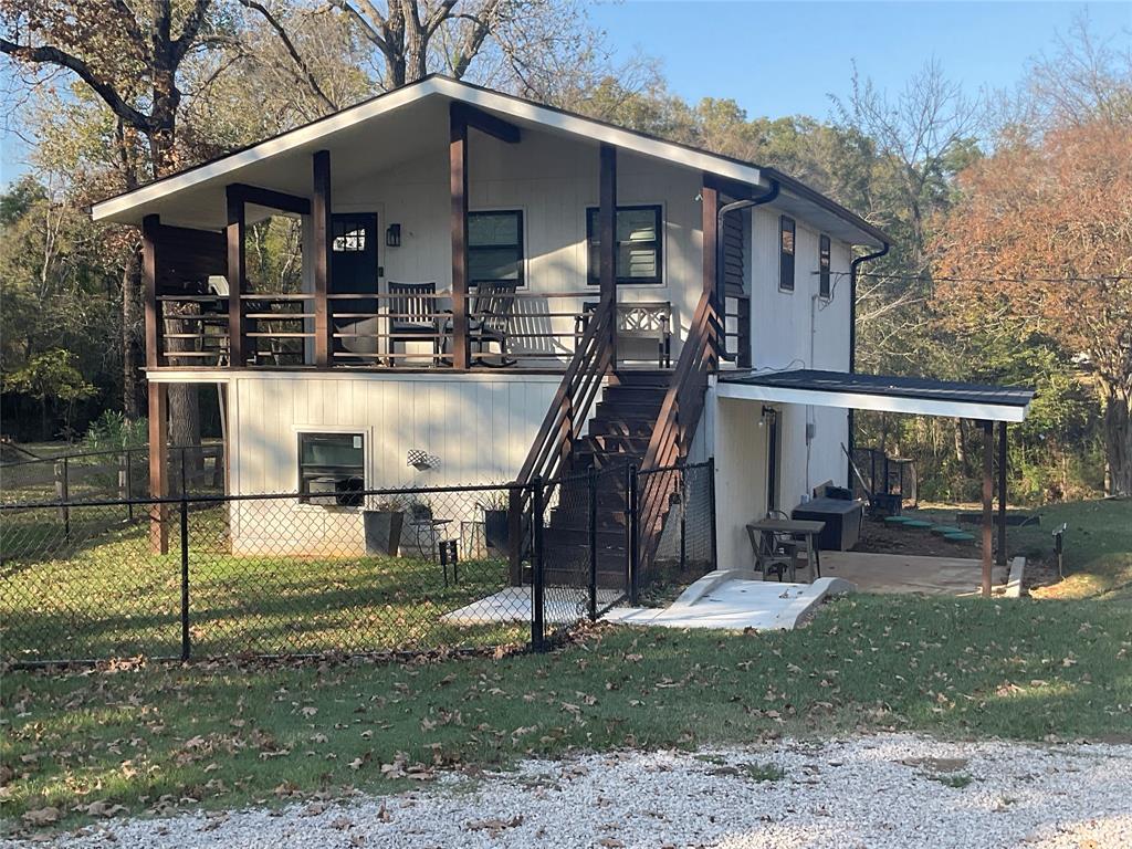 Charming Two-Story Channel-Front Home Near the Main Body of Cedar Creek Lake! This beautifully updated waterfront retreat offers the perfect blend of comfort and style on over half an acre. Step inside to an inviting living area featuring a wood-burning fireplace, vaulted ceiling, and designer touches throughout. The kitchen is a showstopper with quartz countertops and stainless steel appliances.  Downstairs offers 2 guest bedrooms, full bath, living area and full utility room. Outside, enjoy the outdoors and entertain & unwind across multiple outdoor living areas—including a covered patio, pergola, and a dedicated fire pit area overlooking the peaceful channel. The large yard offers plenty of room for recreation, pets, or gardening, and the workshop with electric provides excellent space for hobbies or storage.  With two stories of thoughtfully designed space, this home is ideal for both full-time living or vacation rental weekend escapes.