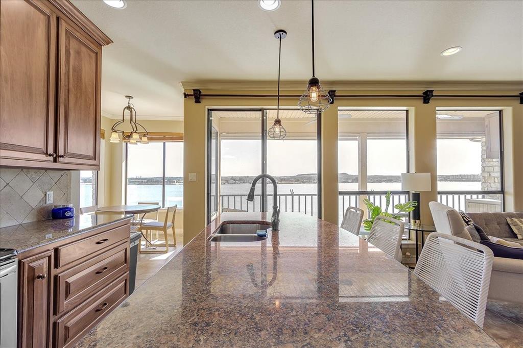 BEAUTIFUL LAKE FRONT CONDO on Lake Granbury!!!  Unit is located on the 3rd floor and gives the most stunning views of the lake.  This floor plan offers some amazing views from the couch or the breakfast table.  The unit is spacious and has plenty of space to stretch out and relax.  The private balcony is covered and makes a great spot to unwind and watch your favorite sports.  Take a stroll to the ever-popular downtown Granbury which is just down the street and enjoy some great food and shopping all within walking distance.  HOA includes the use of the dock, community pool, gym, clubhouse, 2 covered parking spots, water, trash as well as Internet and Cable.