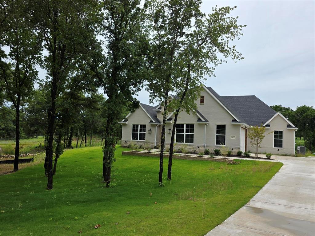 Check out this beautifully designed Kenmark Home situated on a serene 2-acre treed lot in the sought after Escondido Ranches community. This property offers the space, privacy, and functionality you've been dreaming of with convenient access to downtown Weatherford.  Step inside to find a welcoming layout that caters to both functionality and entertaining. A dedicated study at the front of the home provides the perfect space for a home office, library, or flex area to suit your needs. The open-concept living area is bright and inviting, with a 12' Pella slider door that frames views of the surrounding trees and pond. Step outside onto the covered patio, where you can enjoy hosting gatherings, relaxing with a morning coffee, or simply taking in the surroundings. This is the VERY LAST home in the very sought after Escondido Ranches, don't miss out on your chance to own a brand new home in this community!