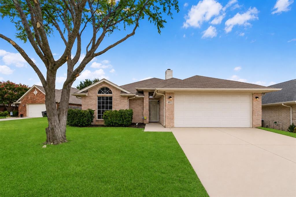 Welcome home to this beautifully updated 3-bedroom, 2-bath residence in the established Coventry Hills community on an oversized lot, zoned to highly sought-after Keller ISD. Step inside to a welcoming foyer that opens into a spacious living room featuring warm wood-look flooring, a cozy corner fireplace, and abundant natural light. The open layout flows effortlessly into the dining area and kitchen, where freshly painted cabinetry, a center island, stainless steel appliances, ample cabinet space, and a pantry provide both style and functionality for everyday living and entertaining. Fresh interior paint throughout the home and updated light fixtures create a bright, refreshed feel. Tucked away for added privacy, the primary suite offers dual vanities, a relaxing garden tub, separate shower, and a generous walk-in closet. Two additional bedrooms and a full bath are thoughtfully positioned on the opposite side of the home from the primary making it an attractive split floor plan, offering flexibility for family, guests, or a home office. Step outside to a covered patio overlooking a spacious fenced backyard with plenty of room to relax, entertain, or play. This move-in ready home is conveniently located near shopping, dining, parks, and major roadways while being served by highly acclaimed Keller ISD.