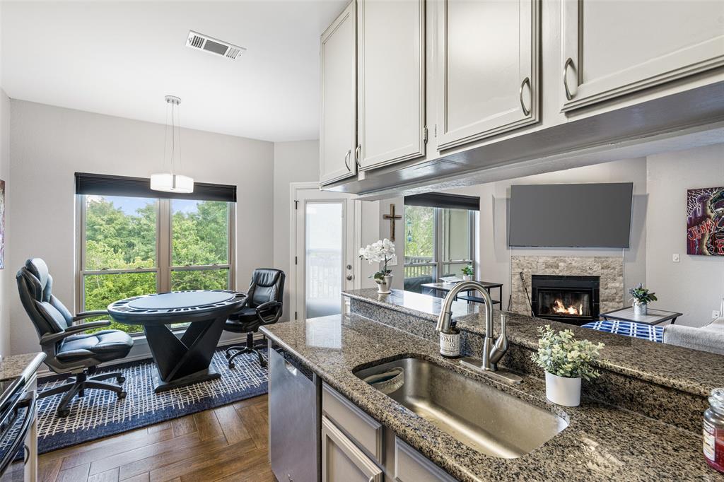 **UPDATED CONDO is in the Heart of the Popular LAKE HIGHLANDS!*A Rare Find w-BOTH a 1-CAR GARAGE and BREATH-TAKING CREEK-GREENBELT BALCONY VIEW...at an INCREDIBLE New Price, Seller relocated & Move-In Ready! Updated Sleek Kitchen w-Granite Countertops & Breakfast Bar, Appliances, Updated Lighting-Ceiling Fans & Fixtures*Additional Cabinetry offers Generous Storage Space! Living Room has a Modern Stone-Framed Wood-Burning Fireplace w-TV Mount Above FP**Stylish Wood-Look Ceramic Tile Flooring laid in an Elegant Herringbone Pattern throughout the Home*Newer Windows, Window Treatments, Patio Door, Dishwasher*Addt'l 2025 updates include Hot Water Heater, New Toilet, New Garbage Disposal! *Full-sized WD Utility Area off the Kitchen! Plenty of Windows Provide Lots of Natural Interior Light!  Nestled in Nature, Overlooking a Beautiful Tree-Lined Creek w-Expansive Greenbelt...Enjoy your morning coffee, listening to the birds sing from your exterior balcony! NO WATER BILL...HOA includes Water & Trash! Oaks On The Bend Condos offer a Community Pool and are Conveniently Located Close to Nearby Shopping, Dining, White Rock Lake Park & Trails! Easy Access to DART Transit or Short Drive to Northpark Mall or Vibrant Uptown Dallas area! *Award-Winning Richardson ISD School District and White Rock Elementary School - one of the Highest-Rated Elementary Schools in Dallas! Vacant & Move-In Ready! Note: Condos ARE approved for 100% VA or Conventional Financing with 10% down!