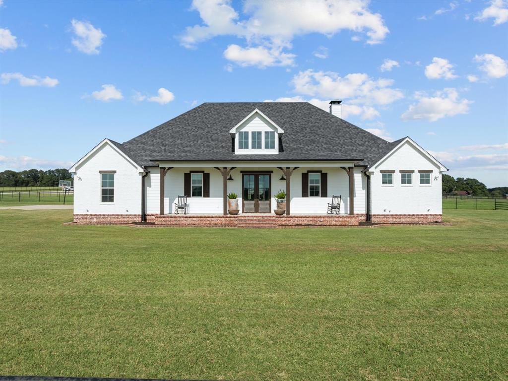 Experience upscale country living on 35+ acres in the scenic countryside of Lindale, Texas.  Property features a beautifully maintained 3-bedroom, 3 -bathroom home offering the perfect blend of country living and modern comfort. Open concept living and dining areas with plenty of natural light, amazing kitchen with ample storage and modern appliances, a designated office or additional bedroom, and extra-large utility room with sink. Comfortable and inviting layout, perfect for both everyday living and entertaining.  Designed with both relaxation and functionality in mind, the property features a wealth of amenities ideal for horse lovers.  The pipe and stay tight wire arena was thoughtfully thought out, measuring 150' x 300' with a Preifert Roping Chute and a pen for calves.  The barn has 4 - 12x60 runs with a center cut gate to make 8 -12x30 runs, a 12x30 storage, feed and hay room, as well as a 50 amp RV plug for trailer parking, and ample space for equipment, vehicles, or additional storage. There is a 22 acres coastal field and 4 - 2 acre turnouts each with a loafing shed! Gated entry with house located at the back of the property for privacy and room to expand!  Come take a look at this immaculate property today!