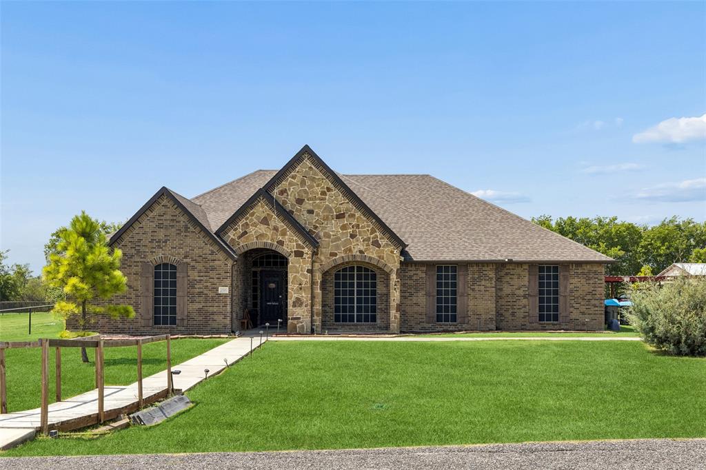 Escape to peaceful country-style living on a beautiful one-acre lot with no HOA, where privacy, comfort, and exceptional outdoor living come together. This inviting home features an open-concept floorplan filled with natural light and offers two spacious living areas, making it ideal for both everyday living and entertaining. The main living room is anchored by a charming stone fireplace and flows seamlessly into the kitchen and dining spaces. Durable wood-look tile flooring extends throughout the home, providing a stylish, low-maintenance finish, while brand-new carpet adds comfort in all the right places. The spacious primary suite is a relaxing retreat with abundant windows, and the beautifully remodeled ensuite bath showcases a stunning new shower and soaking tub designed for relaxation after a long day. All bedrooms feature ceiling fans and generous closet space. Step outside to your own backyard oasis, complete with a sparkling blue swimming pool (pool pump recently replaced), cabana, expansive patio areas, and plenty of green space for recreation, pets, or gardening. A three-car garage, ample additional parking, and an easily accessible attic provide exceptional storage and convenience. Energy-efficient solar panels help reduce utility costs and keep the home comfortable year-round during the Texas seasons. The Tesla power wall provides power even during storms-outages and allows solar to charge.  Located in a wonderful neighborhood that offers the perfect blend of tranquility and convenience, this move-in-ready property is a rare opportunity. Schedule your private showing today and experience all this incredible home has to offer!