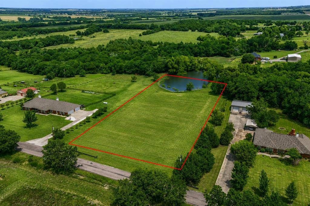 Escape to the peace and beauty of country living with this exceptional 2.19-acre homesite, offering the perfect setting to build your dream home. Nestled in a serene rural setting, this property features a fully stocked pond that is truly a fisherman's dream, providing endless opportunities for relaxation and recreation right in your own backyard. Enjoy wide-open spaces, picturesque views, and plenty of room for a custom home, workshop, pool, or outdoor living area. Whether you're looking for a private retreat or the ideal place to create your forever home, this rare property offers the best of country living while still being conveniently located near everyday amenities. Bring your builder and your vision—this beautiful acreage is ready to make your dream a reality!