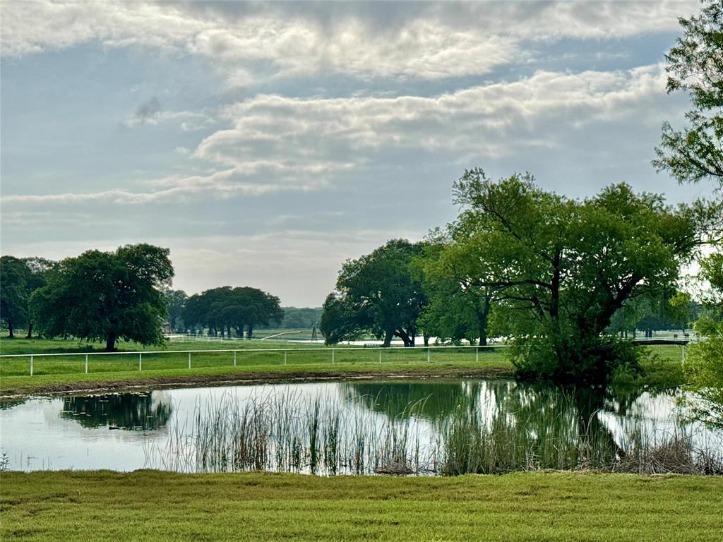 Located in one of North Texas' premier horse country settings, this equestrian property offers a unique combination of comfortable living and well-designed horse facilities.
The ranch-style home features quality craftsmanship throughout with custom woodwork, rich cabinetry, distressed wood flooring, and wood beam accents. Offering 4 bedrooms and 3.5 baths, the home provides an open layout suitable for both everyday living and entertaining.
Outdoor amenities include a pool with water features, outdoor fireplace, and pool house complete with a bathroom, shower, and bar area, creating an ideal space for relaxing and hosting guests.
Designed with the horseman in mind, the property includes a custom-built 10-stall barn, barn apartment, and a 100' x 150' covered arena for year-round riding and training. The barn setup offers flexibility for personal use, training operations, or accommodating guests and staff.
Currently under Ag Exemption, the property provides the functionality needed for an equestrian operation while maintaining the comfort and privacy of country living.
Conveniently located with easy access to nearby amenities, this property presents a rare opportunity to own a complete horse facility with quality improvements, comfortable living spaces, and the infrastructure to support a variety of equestrian pursuits.
