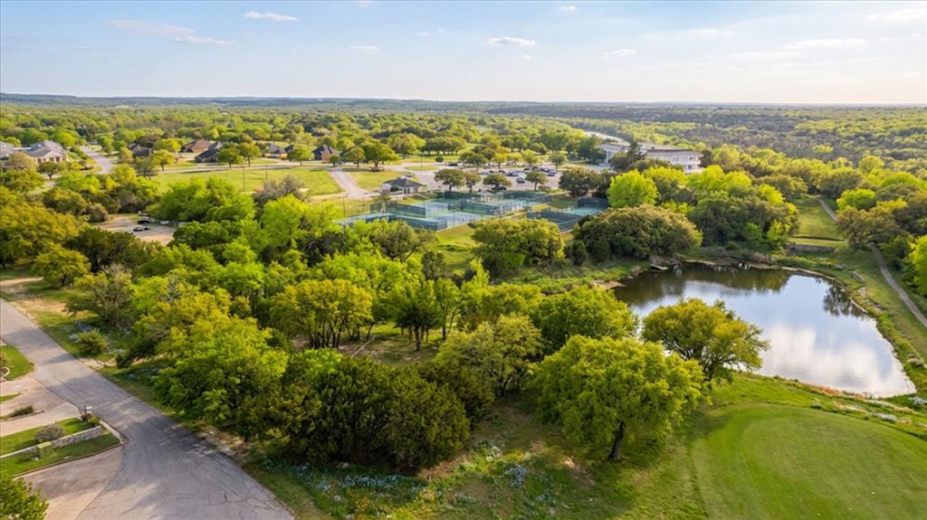 Discover the perfect opportunity to build in the highly sought-after, gated community of Pecan Plantation. This 2.5-acre lot offers an ideal blend of privacy, space, and convenience, located just steps from the clubhouse and premier community amenities. This property already has retaining walls in place and 2 building pads, one main pad on the main street and one further in the property, saving you time and expense as you plan your custom home. With gently contoured terrain, access to ponds, storage area that is fence, and thoughtful groundwork already established, this lot is well-suited for a variety of home designs. Enjoy all that Pecan Plantation has to offer, including golf, clubhouse, swimming pools, tennis courts, equestrian facilities, private airstrip, marina access, and 24-7 guarded security, all within a peaceful, country club setting.

Whether you’re ready to build now or invest for the future, this spacious lot presents a rare opportunity in one of Granbury’s most desirable communities.