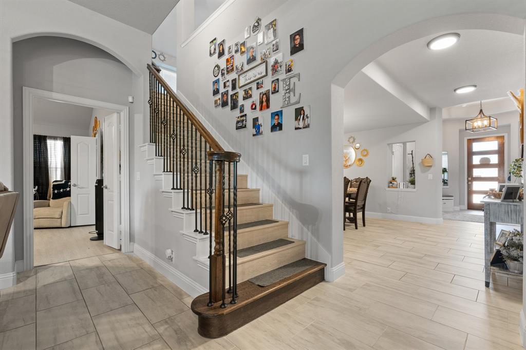 Seller is offering 10,000 in seller concessions to be used for closing costs or rate buy down. Welcome to 505 Livia Street, a stunning Bloomfield-built home nestled in the sought-after Parks at Panchasarp Farms community of Burleson, TX. Built in 2023 and backing to a peaceful greenbelt, this 5-bedroom, 3.0-bath home offers 3,291 square feet of luxurious living space designed for comfort, style, and functionality. Step through the elegant 8-foot mahogany front door into a rotunda-style entry that opens into an expansive open-concept living area. The chef’s kitchen is a standout with exotic granite countertops, stainless steel appliances including double ovens and a gas cooktop, a vented hood, and abundant cabinetry. Designer flooring, a stacked-stone fireplace, quartz countertops in the bathrooms, and thoughtfully integrated built-ins add a layer of sophistication throughout. The spacious primary suite is located on the main floor and features dual vanities, a garden tub, separate shower, large walk-in closets, and a private sitting area. Upstairs, enjoy a generously sized game room and a dedicated media room—perfect for family nights or entertaining guests. Outside, a covered patio with accent lighting overlooks a fenced backyard with direct access to the scenic greenbelt, providing a peaceful retreat for outdoor enjoyment. Located in highly rated Joshua ISD, with convenient access to schools and shopping, this home offers the perfect blend of upscale finishes and everyday livability.