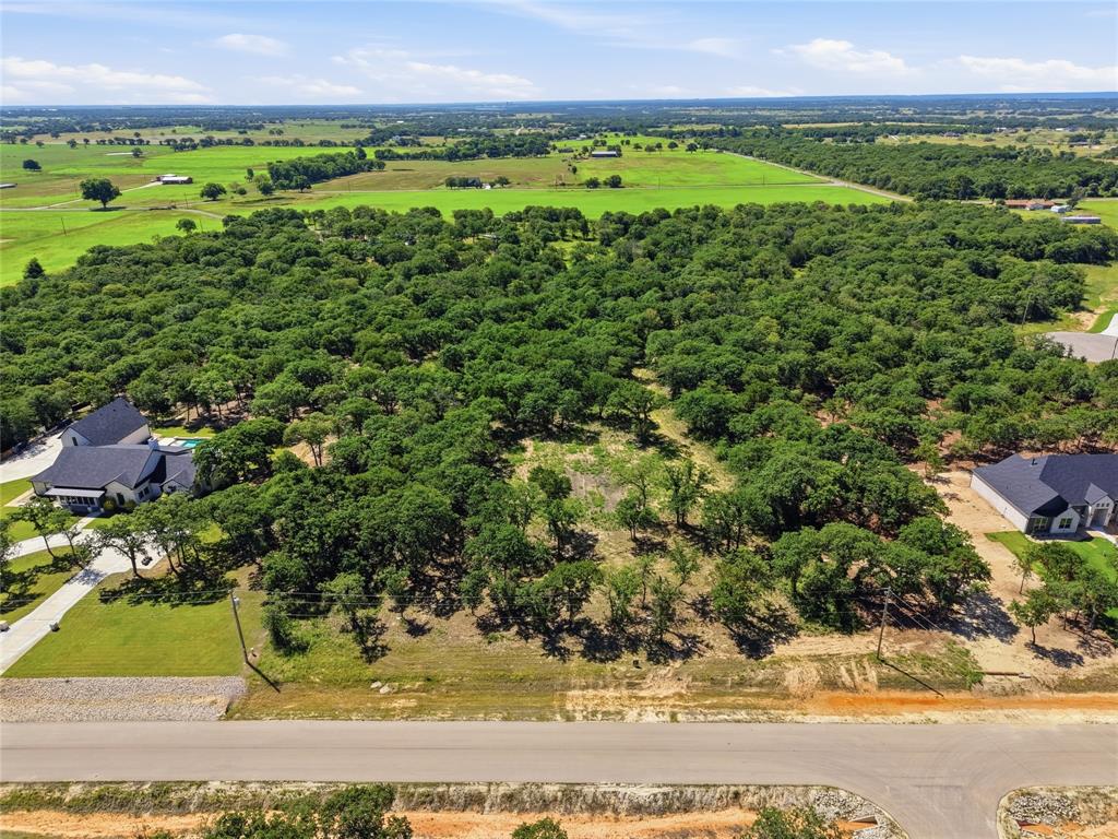 Price Drop!!!! Discover the perfect blend of open space and natural beauty on this stunning 4+ acre homesite located in the desirable Bella Oaks subdivision in Tolar. The property has already been partially cleared, saving you that cost, while preserving over 2 acres of mature trees, offering privacy and a peaceful setting surrounded by nature.

Enjoy the quiet charm of the neighborhood, featuring thoughtfully designed homes and a welcoming atmosphere. Wildlife is frequently seen throughout the area, adding to the serene environment. Horses are permitted per HOA guidelines, providing added flexibility for a variety of lifestyles.

Conveniently located less than 15 minutes from Granbury, this property offers the best of both worlds: a tranquil setting with easy access to shopping, dining, and everyday amenities.

Just waiting for you to come and build your dream home!