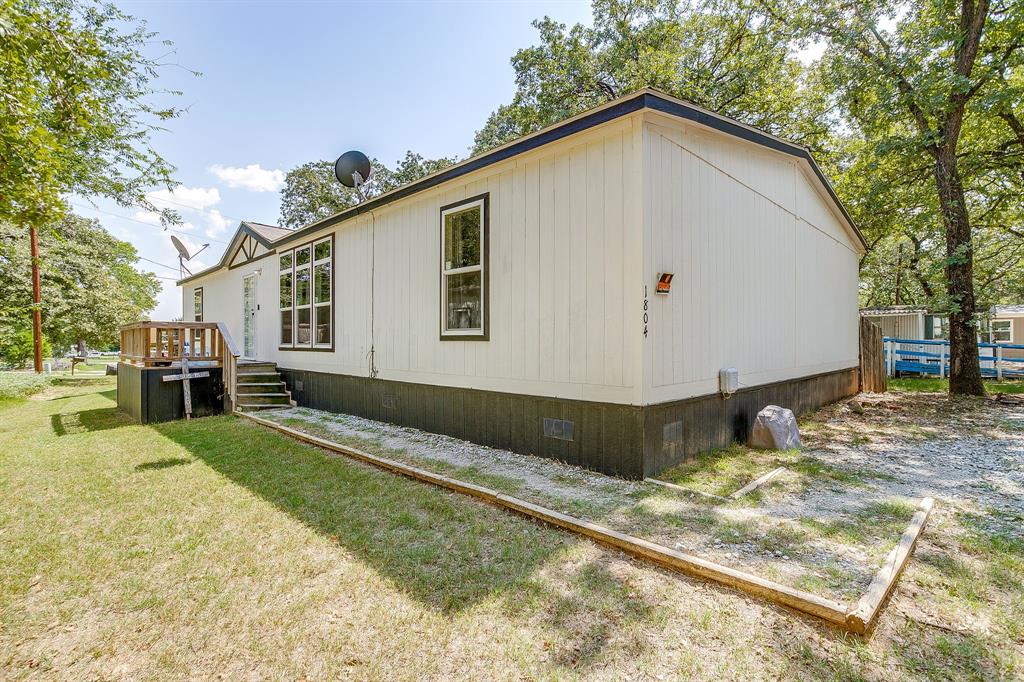 Welcome to 1804 Coral Rd! Built in 2021, this beautiful manufactured home in Azle ISD offers 4 bedrooms, 2.5 baths, and a smart layout designed for comfort and convenience. The open-concept design features a spacious living area and a chef’s kitchen with an oversized island perfect for family meals, entertaining, or working from home. The Jack & Jill bath connects two secondary bedrooms, while the fourth bedroom offers flex potential as an office, playroom, or guest space. The primary suite is a retreat with dual walk-in closets, a soaking tub, and a separate shower. Guests will appreciate the additional half bath. Enjoy modern finishes, a functional layout, and all the space you need, just minutes from schools, shopping, and Eagle Mountain Lake. Don’t miss this move-in ready home in desirable Azle ISD!
