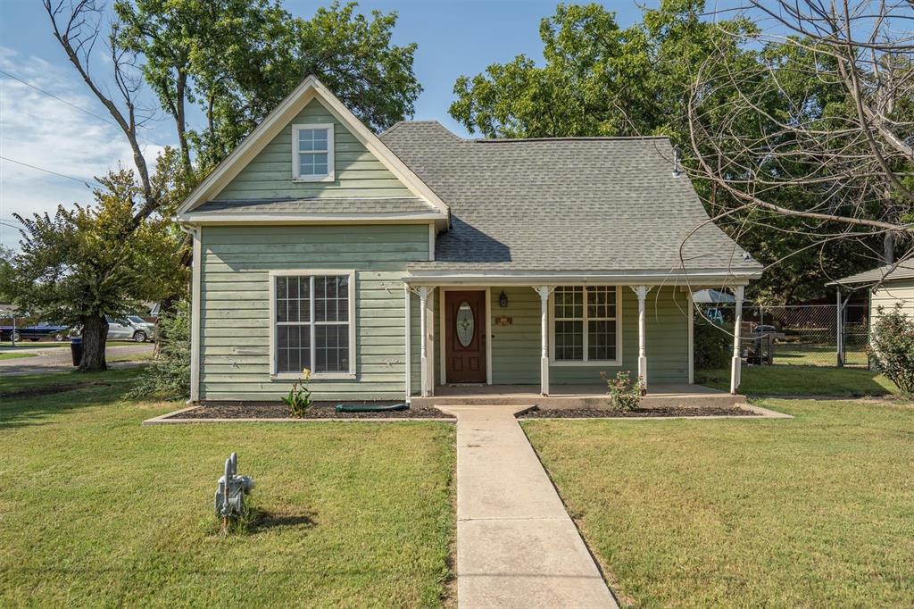 Charming Home in the Heart of Tioga – Packed with Potential!

Welcome to a warm and inviting home located directly across from the city park and playground in desirable Tioga ISD. With solid wood craftsmanship touches throughout—including hardwood cabinets, doors, and trim—this property is ready for your personal touch and upgrades to make it your own.

Step inside to discover a flexible layout featuring two living areas (or use as an additional bedroom), includes walk-in closets, and a cozy wood pellet fireplace perfect for cooler evenings. Enjoy comfort year-round with a Trane 13 SEER HVAC system and energy-efficient low-E windows.

Outside, you'll find plenty of space for all your needs, including a 2-car carport, a garage workshop with overhead door, and ample additional parking—ideal for guests, hobbies, or extra vehicles.

Whether you're looking to update or simply settle into a peaceful small-town lifestyle, this property offers endless potential in a great location. Don't miss your chance to make this one yours!