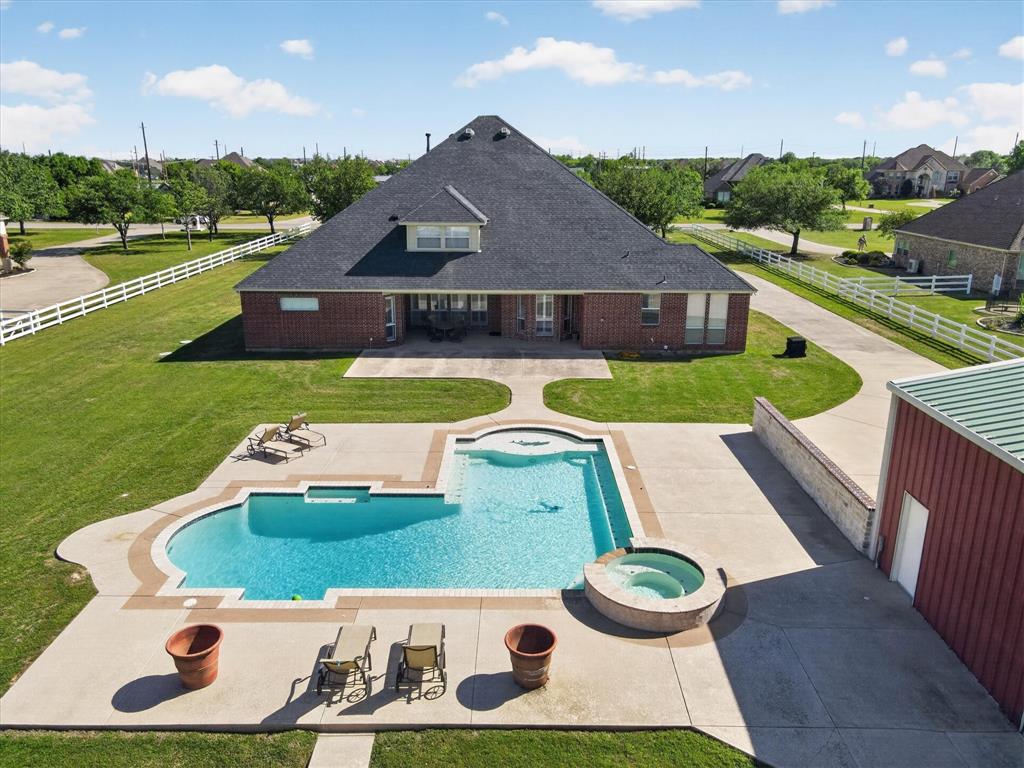 Spacious and well-appointed, this 4,610 square foot home—built in 2001—sits on approximately 1.5 fully fenced acres, offering privacy and room to spread out. A gated entrance, circular driveway, and enhanced landscaping create a welcoming first impression.
Inside, the home features multiple living and entertainment spaces, including a dedicated media room complete with media equipment and a game room with a pool table that conveys with the property. The flexible layout offers a variety of options for everyday living, entertaining, or working from home. Seller is offering a $10,000 decorating allowance for an acceptable offer.
Outdoors, enjoy an oversized pool and expansive grounds, along with a large workshop ideal for projects, storage, or hobbies.
With its generous space, thoughtful features, and unique amenities, this property offers a versatile and comfortable living environment. Workshop is 48 X 30.