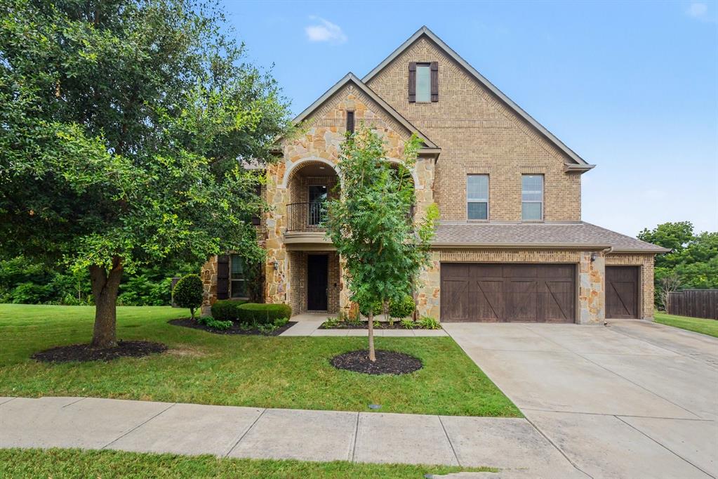 From the moment you arrive, this stunning stone and brick home makes a statement. Inside, soaring ceilings and abundant natural light create an open, inviting atmosphere. A dedicated home office with tray ceilings provides the perfect work-from-home space. The formal dining room is perfect for hosting, while the open-concept living room and eat-in kitchen are designed for everyday living and entertaining. The kitchen features dark-stained cabinetry, a large center island, breakfast bar, two dishwashers, new double ovens, and a new refrigerator.

The ground-floor primary suite offers tray ceilings and a beautifully appointed ensuite with dual vanities, a soaking tub, dual showerheads, and a frameless glass shower. A fifth bedroom with an adjacent full bath is ideal for guests or multigenerational living. Upstairs you'll find a spacious loft with built-in cabinetry and desk, a private balcony, a media room, and four generously sized bedrooms, each with its own walk-in closet.

Major updates include paid-off solar panels, a new HVAC system, tankless water heater, luxury vinyl plank flooring throughout the main level, and new plush carpeting upstairs. A covered back patio and fenced backyard complete this exceptional home.

Located in the sought-after Wiskbrook Estates, this home is zoned to Gary & Bobbye Jack Minshew Elementary, Dr. Jack Cockrill Middle School, and McKinney Boyd High School, with convenient access to Highway 75, the Sam Rayburn Tollway, Historic Downtown McKinney, Stonebriar Centre, and Legacy West.

Homes like this in Wiskbrook Estates rarely become available. Schedule your private tour today!