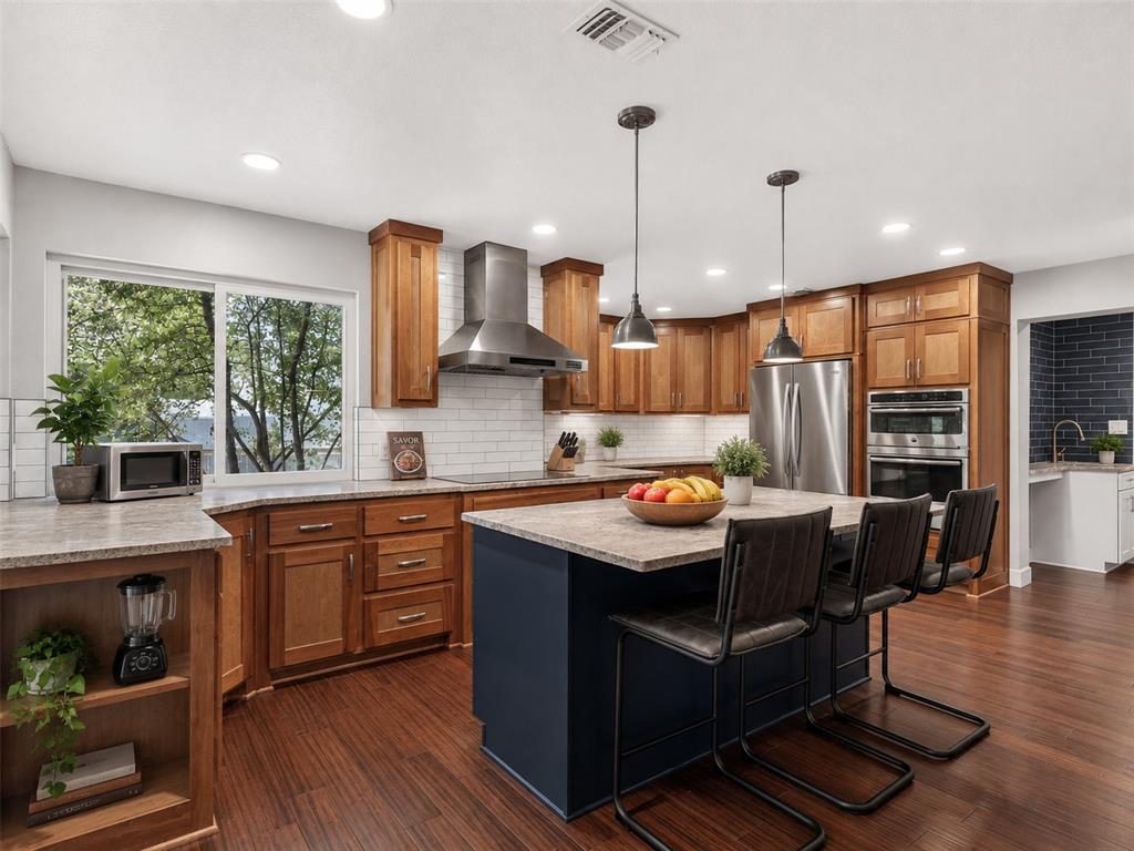 Set on an oversized lot in a pride-of-ownership neighborhood near Eagle Mountain Lake, 7733 Woodside blends character, comfort, and beautifully curated upgrades. A vaulted family room with a striking rock fireplace and wet bar creates the perfect setting for effortless entertaining. Just beyond, a spacious sunroom filled with natural light offers the ideal place to relax year-round, with peaceful views of the adjacent greenbelt that make every morning coffee or evening unwind feel a little more special.

The split primary suite is a true retreat, complete with its own cozy fireplace and a spa-inspired bath featuring a walk-in shower and soaking tub. Outdoors, there's plenty of room to spread out, while the oversized garage, storage shed, and abundant storage throughout the home keep everything organized—perfect for hobbies, outdoor toys, and all your lake gear.

Recent improvements bring both style and peace of mind, including a 2026 roof, gutters, garage door, sunroom ceiling and lighting, courtyard siding, backyard screens, and a beautifully resurfaced guest bath backed by a 5-year warranty. The kitchen cabinets were freshly re-stained to complement the stunning 2021 kitchen remodel, highlighted by one-of-a-kind leathered granite countertops. Additional updates include grab bars in the primary bath, a newer electrical panel, and two new water heaters installed between 2024 and 2026.

Love the lifestyle as much as the home: enjoy an optional HOA with pickleball and tennis courts, plus nearby boat ramps that make getting out on Eagle Mountain Lake quick and easy. From lively gatherings with family and friends to quiet evenings in the sunroom, this rare move-in-ready home offers the perfect balance of established charm, thoughtful updates, and everyday comfort.