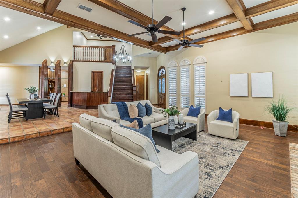 This Beautiful Home is a Must See and has a ton to offer a new family.  The home is situated on a beautiful 
corner lot that is slightly elevated, giving it a majestic feel as you pass by.  The seller is willing to remove 
rocks and add sod before close if preferred.  With 4 bedrooms, 4 bathroom and 3,788 well-appointed 
square feet of luxury living space, this home is certainly an entertainer’s dream.  As you enter through the 
front doors, the large open foyer, living and dining area invite you in with beautiful natural wood trim and 
stair case as well as real stone tile and wood floorings giving a feeling of warmth and custom finish.  
Further into the home, you’ll find a custom bar built into the corner of the staircase that features a sink, 
wine rack, storage and a wine or beverage cooler that can be set to that perfect temperature for your white 
wines or cooler for other drinks.  The kitchen features granite countertops, a large island with a hoodless 
cook top and plenty of prep space.  There are more cabinets than any large family could ever fill as well as 
a very decent sized pantry.  Multiple built-ins also offer increased storage space.  The primary bedroom 
offers the comfort of its own fireplace and a large bathroom with lots of natural lighting.  Each bedroom in 
the home has their own bathrooms for ultimate comfort and privacy.  The home also features an office or 
game room with lots of windows for natural light and a nice view of the pool and back yard oasis.  Step 
through the arched double doors onto the cover patio and pool area with space for comfortable lounge 
furniture and entertaining. Buyer to verify schools and measurements.