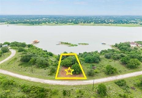 Here's your chance to own a LAKEFRONT property at King's Point Cove for just $150,000. The property features many beautiful, established oak trees, generally level land in the front for your dream home, and rugged terrain in the back to show off your true Texas spirit.  Enjoy the many benefits of King's Point Cove, including golfing at the challenging golf course, swimming at the Hideout pool, kayaking, paddle boarding, fishing, and fine dining at the resort restaurant.  Water, sewer, and electricity are all available. Whether you are looking for a forever home or a vacation getaway, come and give this property a look.