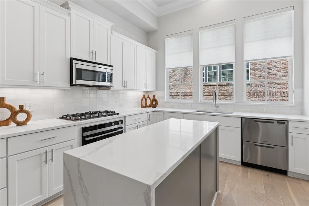 Stunning townhome minutes from Downtown Dallas, Oak Lawn, and the Dallas Medical District. Sophisticated 2-bed, 2.5-bath design by InTown Homes at Cedar Branch features high-end finishes throughout. The open-concept design, 12-foot ceilings, abundant natural light, and striking open staircase dividing the living and dining areas create an impressive sense of space and architectural interest. The gourmet kitchen features a Fisher & Paykel stainless steel appliance package, exquisite quartz countertops, upgraded waterfall island, tile backsplash, and soft-close cabinetry. The primary suite provides an ideal space to unwind, complete with 11-foot ceilings, a spacious walk-in shower, dual vanity, and walk-in closet. Sustainable engineered hardwoods throughout add to the upscale feel of the home, while the 2-car tandem garage provides ample space for parking and additional storage. Enjoy a private rooftop deck with sweeping views stretching from the Dallas Medical District to Downtown Dallas. Community amenities include lush landscaping and a charming resort-style pool. PLEASE GO TO MODEL HOME FOR ALL OPEN HOUSES - 4601 GREENBOROUGH LN.