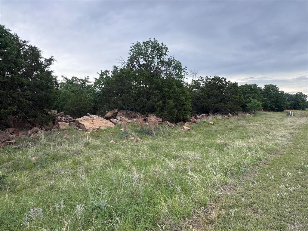 This unique Clayton Mountain homesite offers a park like setting with direct access to a community hiking area. Large oak trees, beautiful rock outcroppings, abundant wildlife, breathtaking views in every direction…what more could you wish for in a location for your dream home? The community offers a robust list of resort amenities including pools, fishing lakes, hiking trails, workout facility, horseback riding stable, and more! The location is only an hour west of Fort Worth making it easy to get back to the big city. But wait until you see the quant communities in immediate proximity to the neighborhood! Gordon is a wonderful community with hardware store, restaurants, gas stations, and many other basic necessities. And if you don’t know the school is one of the premier six man football programs in Texas with state championship trophies to prove it! The school is the heartbeat of the community! And just down he road you will find the brand new Palo Pinto Mountains State Park…a fantastic destination to visit often. The small towns of Santo, Strawn, Mingus, Thurber and Palo Pinto are just short drives away…each offering their own unique experiences, retail and service providers. Make plans to see this great property and explore all the community has to offer!