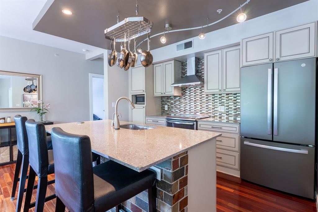 Modern Stunner exudes the finest city living Oak Lawn has to offer! Looking for a meticulously custom renovated condo a step above all others? Look no more, this is it! This condo is one of the largest units on the property. BONUS FEATURE! TWO ASSIGNED COVERED GARAGE SPACES AS WELL AS A SPACIOUS STORAGE ROOM! Beautiful two bedroom, two bath open floor plan condominium in the heart of OakLawn with many custom features including Brazilian cherry wood floors, custom walk in closet with built in tie and belt racks, separate study with built in entertainment center and desk, granite counters, stainless appliances, double sink. Kitchen is open to living and dining areas. Features a large balcony, and full size utility closet.  Two parking spots in garage #12 and #13 . Storage unit S-9 located directly behind parking spots