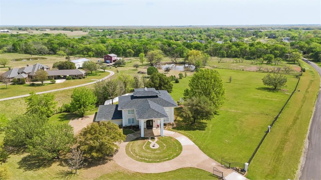 Beyond the gated entry, a sense of privacy and tranquility envelops this refined estate. Spanning over 5,000 square feet of thoughtfully designed living space, it boasts a resort-style pool and the rare freedom of Texas acreage. The grand foyer, with its soaring 30+ foot ceilings, immediately creates a sense of scale and light.

Strategically located between Lake Ray Hubbard and Lake Tawakoni, the property offers close proximity to Rockwall and Dallas. It’s also near Bishop Field (68TS) private airport in Royse City. The main residence, gracefully situated on approximately 3 acres, features expansive rooms, 10-foot-plus ceilings, and a flowing layout. This creates an atmosphere that’s equally suited for intimate everyday living or elegant gatherings. With 5 bedrooms and 3 full bathrooms, the home offers ample space, comfort, and versatility without compromising on sophistication.

What truly sets this property apart is the separately platted 1-acre parcel. This opens a world of possibilities that are rarely found at this level. Imagine a private guest house, a future residence, or the option to sell or hold the parcel as an investment. Alternatively, you could combine both parcels to enjoy a seamless 4-acre private retreat.

This estate is more than just a home; it’s a canvas for your vision, lifestyle, and dreams.