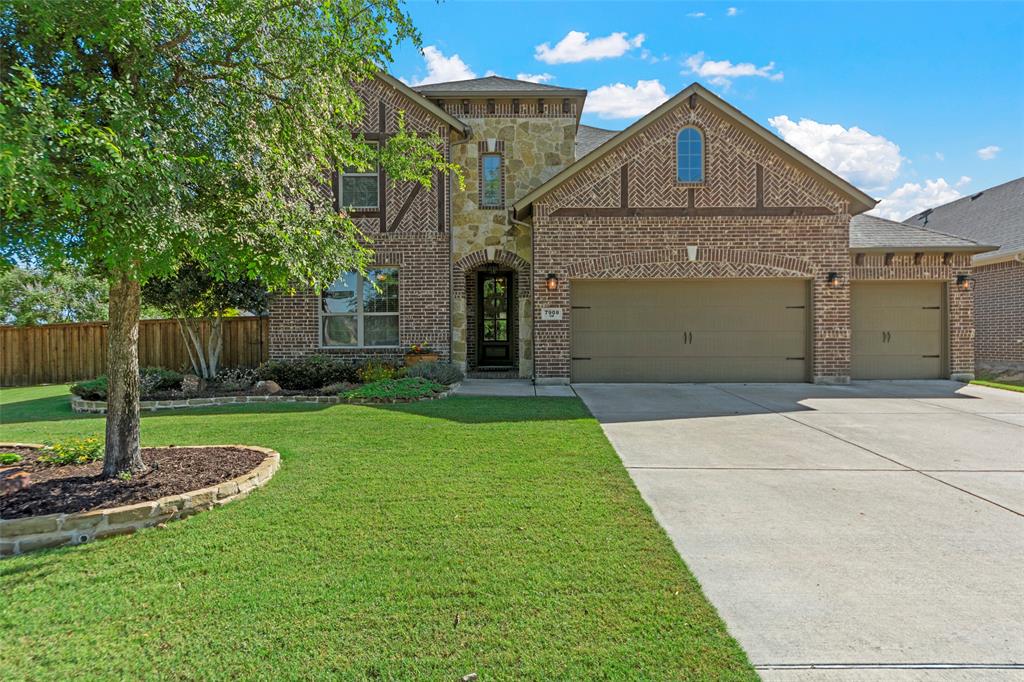Stunning two-story brick and stone home situated on a large corner lot with exceptional curb appeal and a spacious 3-car garage. Inside, you’ll find soaring ceilings, rich hardwood floors, and an impressive spiral staircase that creates a grand first impression. The thoughtfully designed floor plan includes a private office, versatile flex space open to below, and an upstairs media room perfect for entertaining. The gourmet kitchen features stainless steel appliances, a gas cooktop, double ovens, oversized island, quartz counters and backsplash, and a sunny eat-in dining area ideal for everyday living. The luxurious first-floor primary suite offers a spa-like ensuite bath with dual vanities, soaking tub, separate shower, and a large walk-in closet. Upstairs bedrooms include ensuite bath access for added comfort and privacy. Step outside to enjoy the large covered patio and outdoor kitchen overlooking an expansive backyard with plenty of room to relax, play, or entertain. This home combines elegance, functionality, and space in every detail.