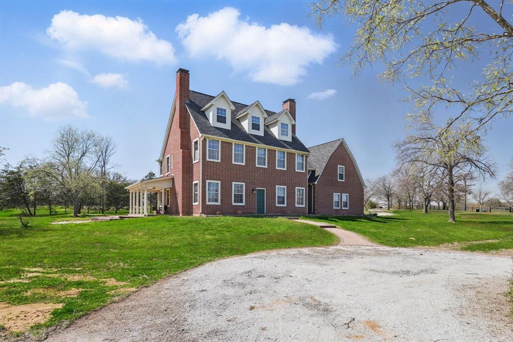 Step into timeless charm with this one-of-a-kind custom colonial-style estate nestled on nearly 8 private acres in the heart of Argyle. Designed with authenticity and craftsmanship in mind, this stunning three-story home features hand-selected beams brought in from New England, giving it a rich, historic charm that’s hard to find in Texas. From the moment you walk in, you'll notice the attention to detail — from the beautifully crafted millwork and hardwood floors to the expansive layout that balances cozy character with modern comfort.

The home offers over 4,300 square feet of living space, featuring 4 oversized bedrooms, 6 full bathrooms, and multiple flex areas perfect for a home office, gym, or media room. The chef's kitchen anchors the main living area and is ideal for entertaining, with generous prep space. Large windows throughout the home bring in natural light and offer breathtaking views of the surrounding landscape. Upstairs, the third floor provides bonus space that can flex as a game room, guest suite, or creative studio.

Beyond the charm and character, this home’s location offers unmatched convenience. You’re just a short drive from DFW International Airport, making travel a breeze. It’s also minutes from the highly regarded Liberty Christian School and zoned to the award-winning Argyle ISD, one of the most sought-after school districts in North Texas.

Whether you're looking for your forever home or a peaceful retreat with easy access to the Metroplex, this estate offers the perfect blend of craftsmanship, comfort, and convenience. Schedule your private tour today and discover what makes this Argyle gem truly unforgettable.