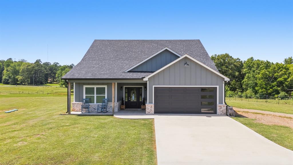 Located on THREE ACRES in the tranquil surroundings of Star Mountain Ranch, this 2024 home is thoughtfully designed providing 1,856 square feet of modern comfort. The property seamlessly blends contemporary features with serene country living, offering an ideal retreat for families, remote workers, and hobby enthusiasts. The home boasts three spacious bedrooms and two well-appointed bathrooms. A versatile office or sunroom offers a flexible space for remote work, hobbies, or additional living needs. With reliable fiber optic internet, residents can enjoy high-speed connectivity suited for work-from-home setups, numerous streaming devices, or uninterrupted movie or sports viewing.
An open and functional floor plan is complemented by abundant recessed (can) lighting that brightens the living spaces. Quality finishes are evident throughout, and a two-car garage provides secure, convenient parking and storage.
The primary bedroom is designed to maximize natural light, featuring multiple windows and a private door leading directly to the back patio. This inviting space is perfect for enjoying peaceful mornings or relaxing with scenic evening views.
Energy efficiency is enhanced by a spray-foamed attic, which also offers a generous amount of floored storage space. The attic includes windows, further illuminating the area with natural light.
Outside, the property features a picturesque pond stocked with bluegill and channel catfish. The land is fully enclosed with field fencing and barbed wire, making it suitable for livestock or hobby farming. A large, covered porch and a back patio provide ideal locations for relaxation and enjoying the abundant wildlife present year-round.
An automatic gate opener adds both convenience and security, rounding out the exceptional amenities of this rural retreat.