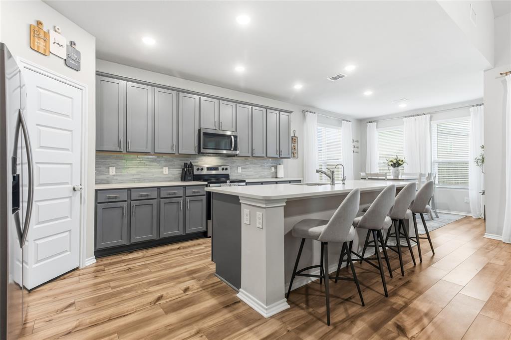 Built in 2023 by HistoryMaker Homes, this immaculate 5-bed, 3-bath home offers 2,995 sq. ft. of modern living. The heart of the home is a showstopper kitchen with quartz counters and a massive island opening to the living area. The primary suite is a true sanctuary with a custom closet system, designer fandelier, and dual-sink ensuite. A versatile guest bedroom is also located on the first floor. Upstairs features an expansive game room and three generous bedrooms and extra storage space. Notable upgrades include a smart home system with Ring security, plus a finished garage with epoxy floors and slatwall storage. Enjoy a quiet cul-de-sac and covered patio in Lake Vista Ranch near Eagle Mountain Lake and local parks. Schedule a tour today!